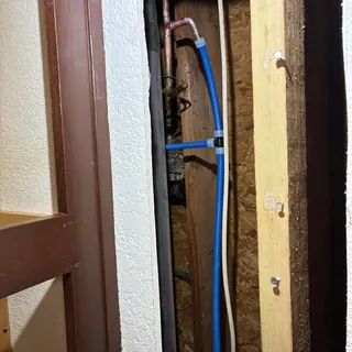 Ice maker cold water line reroute behind wall