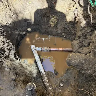 2-inch copper water main pipe break with muddy water