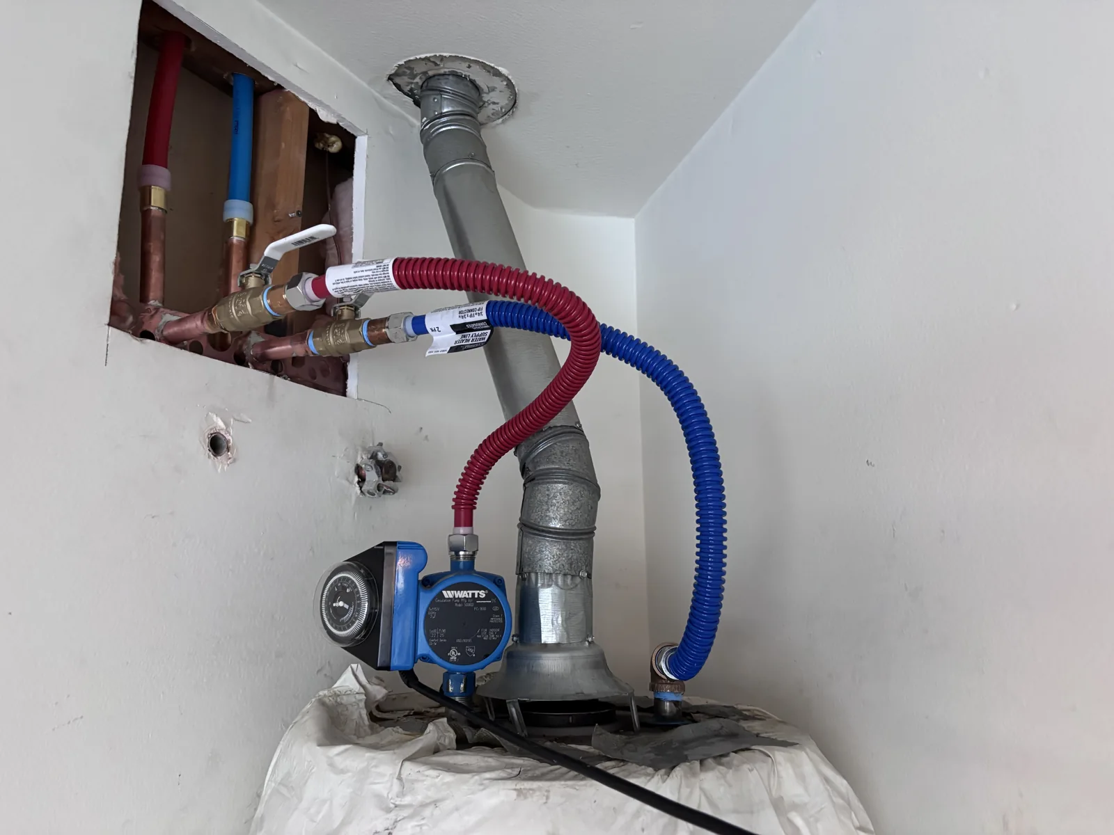 Hot and cold water connections at the water heater during a whole house repipe in The Colony, Murrieta