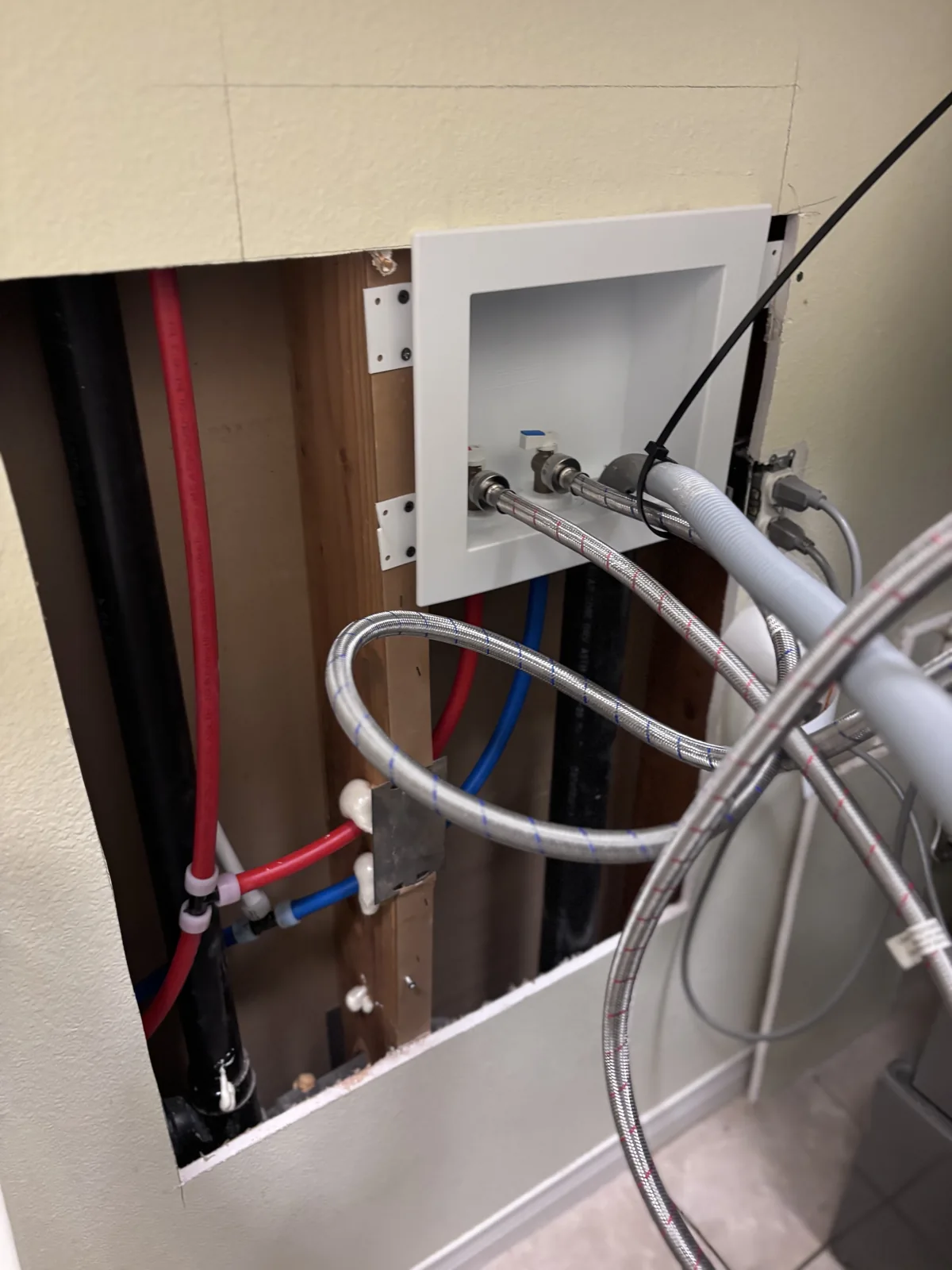 New hot and cold water lines at the laundry hookups