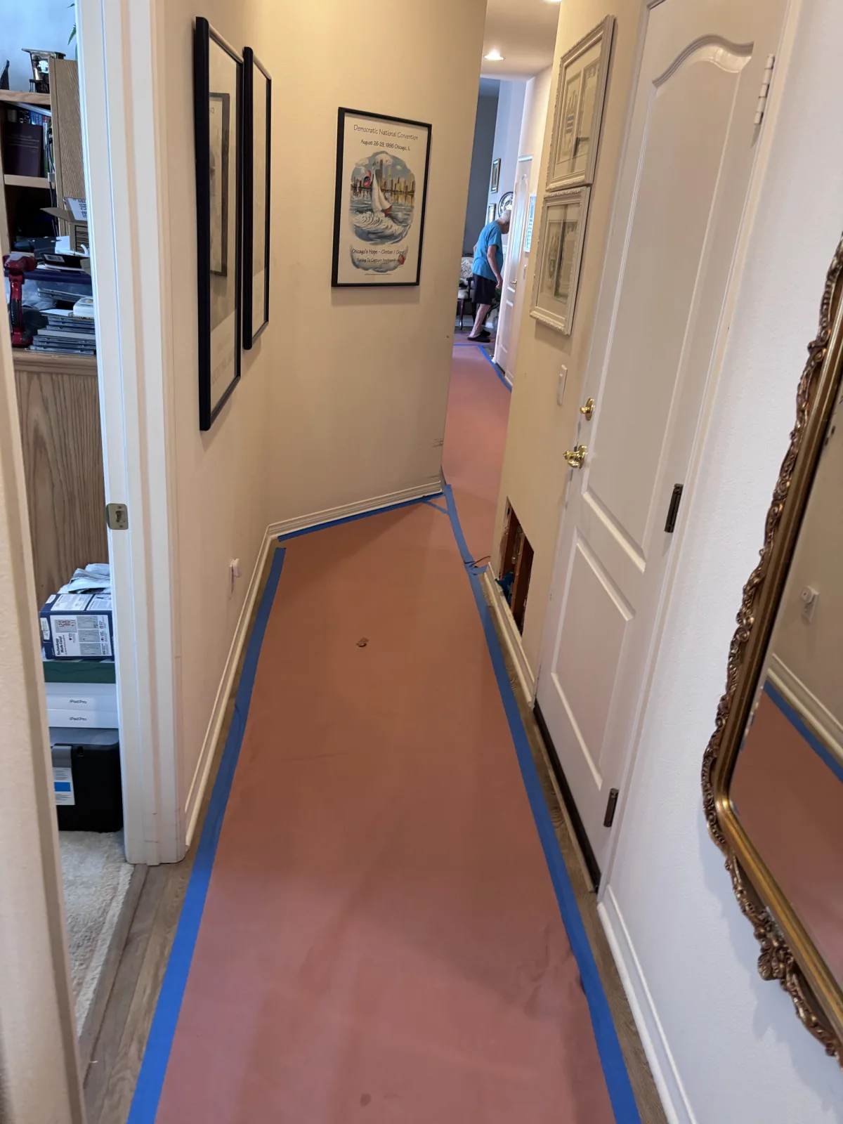 Hallway floor protected with paper and taped edges during repiping