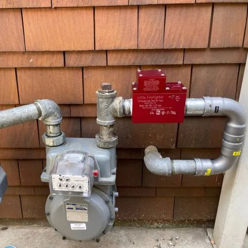 Earthquake gas shut-off valve on gas line.