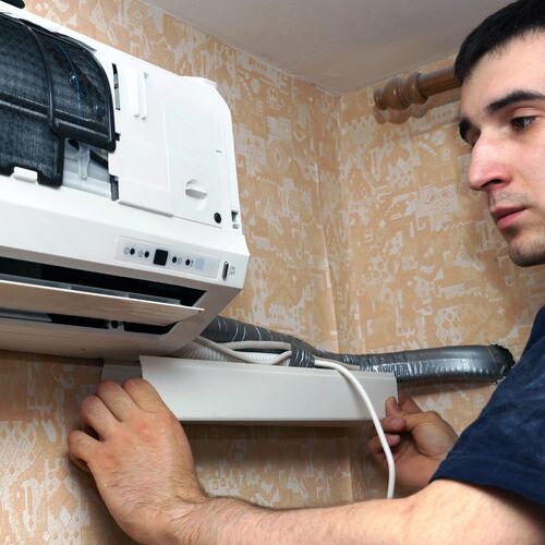 Technician installs mini-split system.
