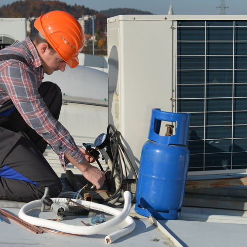 Technician works on commercial HVAC.