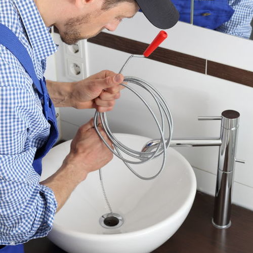 Drain cleaning by a plumber